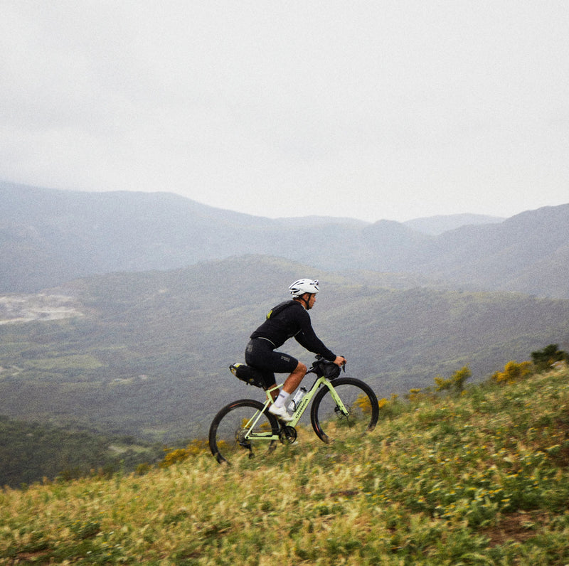 Hjólreiðamaður á Orbea Terra malarhjóli í bikepacking ferð í fjallendi